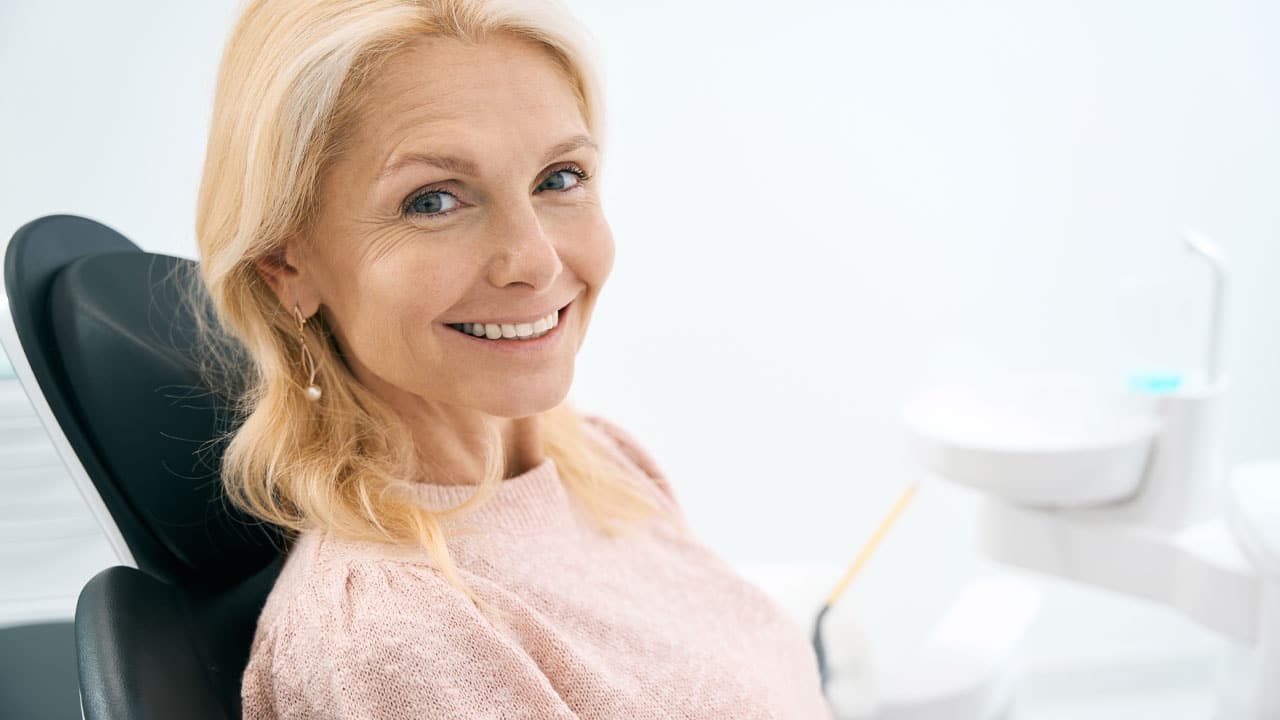 Older woman smiling in dental chair