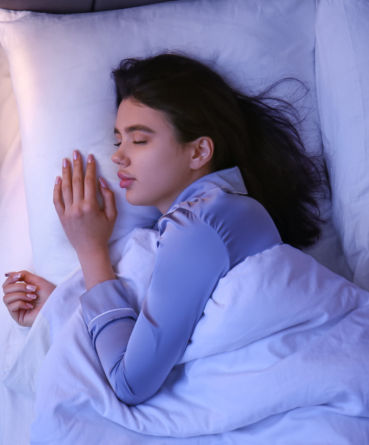 Young woman sleeping peacefully, representing restful sleep after sleep apnea treatment with an oral appliance